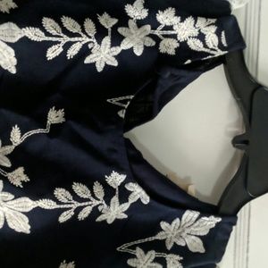 Dark blue and white flowered shirt.